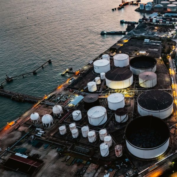 Tank ship loading unloading oil and gasoline at Commercial dock in sea